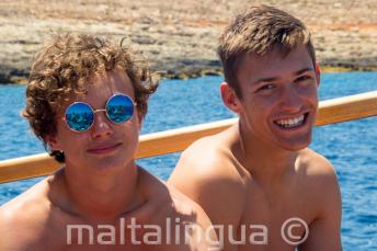 2 chicos sonriendo en un viaje en barco